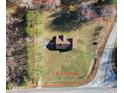 Aerial view showcasing the property's 1.61 acres, surrounded by trees at 3415 Spot Rd, Cumming, GA 30040