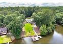 Lush, expansive lot for this lakefront home with private dock, mature trees, and manicured lawn at 590 Yancey Cir, Covington, GA 30014
