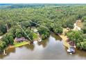 Beautiful lakefront property with mature trees, home and a private dock with space for your boat at 590 Yancey Cir, Covington, GA 30014