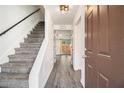 Welcoming foyer with a staircase, neutral walls, and modern gray wood flooring creating a bright and open space at 732 Jamestown Xing, Jonesboro, GA 30238