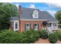 Attractive brick home with a well-maintained lawn, black shutters, and inviting front porch, radiating classic charm at 2610 Ginger Dr, Buford, GA 30519