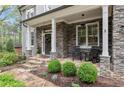 Inviting front porch featuring stone accents, rocking chairs, and professional landscaping at 2811 Shady Valley Ne Dr, Brookhaven, GA 30324