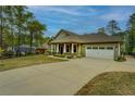 Charming home showcases a well-maintained yard and two-car garage with driveway at 9117 Dearing St, Covington, GA 30014