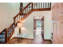 Inviting foyer with a wooden staircase and hardwood floors at 103 Nob Hl, Peachtree City, GA 30269