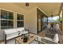 Inviting covered porch featuring stylish outdoor seating, perfect for relaxing and entertaining guests at 158 Hemphill School Rd, Atlanta, GA 30331