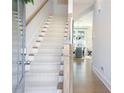 Inviting entryway features hardwood floors and a carpeted staircase at 158 Village Green Ave, Woodstock, GA 30189