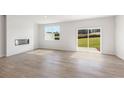 Bright living room with modern fireplace and sliding glass doors to the outdoors at 1945 Westwind Street (Lot 162), Lawrenceville, GA 30043