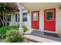 Close-up of the red front doors with decorative glass, framed by white pillars and lush landscaping at 1531 Stone Gate Se Ln, Atlanta, GA 30317
