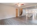 Open-concept living room with hardwood floors, neutral walls, and stairs to the upper level at 3443 Woodshade Dr, Loganville, GA 30052