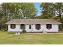 Charming one-story home featuring a manicured lawn and lovely curb appeal with a water fountain feature at 419 Fincher Rd, Covington, GA 30016
