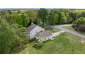 An aerial view of the home showing its placement on a large lot surrounded by mature trees and landscaping at 190 Ccc Rd, Kingston, GA 30145