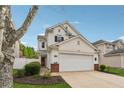Charming two-story home featuring a two-car garage, manicured landscaping, and vinyl siding at 230 Silver Fox Trl, Dallas, GA 30157
