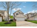 Charming two-story home featuring a two-car garage, manicured landscaping, and vinyl siding at 230 Silver Fox Trl, Dallas, GA 30157