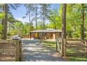 Quaint brick home with a bright yellow front door, complemented by a well-maintained lawn and lush greenery at 3385 Pinehill Dr, Decatur, GA 30032