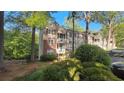 Condominium building with well-maintained landscaping and private balconies at 340 Teal Ct, Roswell, GA 30076