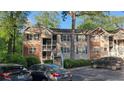 Inviting condo featuring brick accents, vinyl siding, and convenient parking spaces at 340 Teal Ct, Roswell, GA 30076