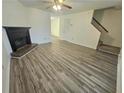 This living room features a fireplace, a ceiling fan, and nearby stairs at 1557 Springleaf Se Ct, Smyrna, GA 30080