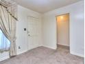 A bedroom featuring a door and a walk-in closet, natural light and neutral carpet at 1245 Shore Dr, Atlanta, GA 30311