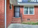 Close-up of the home's front door, brick facade, and adjacent windows at 1245 Shore Dr, Atlanta, GA 30311