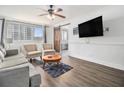 Cozy living room featuring comfortable seating, a ceiling fan, and natural light from the window at 215 Piedmont Ne Ave # 708, Atlanta, GA 30308