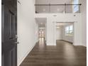 Bright, modern foyer with dark wood flooring, high ceilings, and open view to the living spaces at 3780 Near Star Ln, Cumming, GA 30028