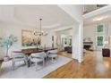 Elegant dining room with tray ceiling, wainscoting and views to the living room at 4062 Vinings Mill Se Trl, Smyrna, GA 30080