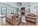 Spacious living room with hardwood floors, fireplace, built-ins, and comfortable seating at 1170 Upper Sweetwater Se Trl, White, GA 30184