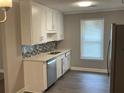 Bright kitchen with stainless steel appliances, modern cabinets, and stylish backsplash at 5516 Westberry Ln, Norcross, GA 30071