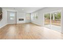Expansive living room with hardwood floors, a modern fireplace, and a sliding glass door to backyard at 7188 Brushwood Bend (115), Lithonia, GA 30058