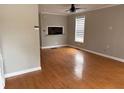 Open living room with hardwood floors, a ceiling fan, and a pass-through window to the kitchen at 810 Martin Se St, Atlanta, GA 30315