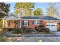 Charming single-story brick home with attached garage and enclosed porch at 948 Sycamore Dr, Decatur, GA 30030