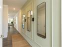 Inviting hallway features wainscoting detail, wood floors and decor mirrors at 2641 Cacao Sq, Acworth, GA 30101