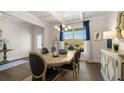 Open dining room with wood table, decorative chandelier, and backyard views at 3790 Near Star Ln, Cumming, GA 30028