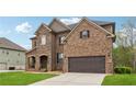 Side view of a two-story home with brick and stone exterior, featuring an attached two-car garage at 245 Piedmont Cir, Covington, GA 30016