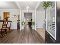 Inviting foyer with hardwood floors, leading to various living spaces, enhanced by a modern light fixture at 245 Piedmont Cir, Covington, GA 30016