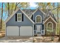 Close-up of a two-story home with a stone facade and an attached garage at 4453 Autumn Glo Ct Ct, Douglasville, GA 30135