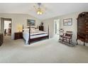 Spacious main bedroom with a vaulted ceiling, neutral carpet, a sitting area, and ensuite bathroom access at 7440 Banks Mill Rd, Douglasville, GA 30135