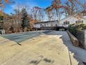 Exterior view of the backyard showcasing a covered pool, with an adjacent deck and fenced backyard at 7440 Banks Mill Rd, Douglasville, GA 30135