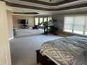 Large main bedroom features sitting area with fireplace and abundant natural light at 1210 Del Mar Club Dr, Dacula, GA 30019
