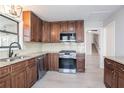 Modern kitchen with stainless steel appliances, gas range, granite countertops, and sleek cabinets at 4809 Burlington Nw Ct, Acworth, GA 30102