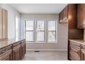 Bright eat-in kitchen featuring light-colored floors, plenty of light and dark wood cabinets with granite counters at 4809 Burlington Nw Ct, Acworth, GA 30102