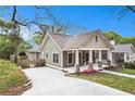 Inviting exterior showcasing manicured lawn, a driveway, and a charming porch; the epitome of suburban elegance at 559 Robinson Se Ave, Atlanta, GA 30315