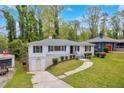 Lovely one-story home with a manicured lawn, private driveway, and freshly painted exterior at 111 Leathers Circle Nw, Atlanta, GA 30314