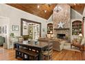 Inviting living room featuring a stone fireplace, wood floors, and large windows at 208 Greenhill Dr, Dallas, GA 30157