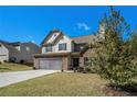Attractive two-story home with a stone facade, a two-car garage and a neatly landscaped yard at 353 Daffodil Dr, Temple, GA 30179