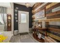 Inviting entryway showcasing stylish wood accent wall, modern lighting, and elegant decor at 353 Daffodil Dr, Temple, GA 30179