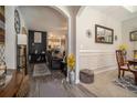 Open-concept living space with hardwood floors, archways, and a glimpse into the kitchen at 353 Daffodil Dr, Temple, GA 30179