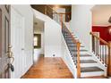 Bright foyer with hardwood floors, staircase, and white trim at 4461 Kentland Dr, Acworth, GA 30101