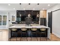 Modern kitchen features a large center island, black cabinetry, and stainless steel appliances at 1010 Violet Sw St # A, Atlanta, GA 30310