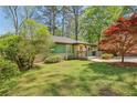 Well-maintained home with a lush green lawn and vibrant landscaping at 952 Columbia Dr, Decatur, GA 30030